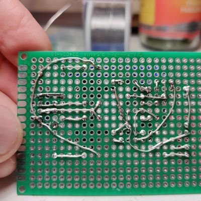 bottom of a circuit board showing okay-ish soldering, I've gotten a lot better since then.